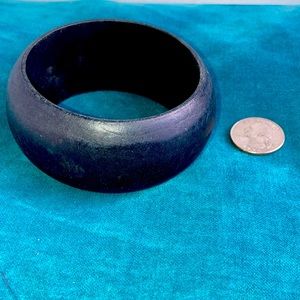 Chunky black wood bangle.